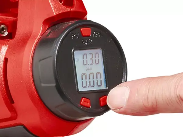 Detail digitálního displeje akumulátorového autokompresoru Einhell CE-CC 18 Li-Solo, prst stiská tlačítko.