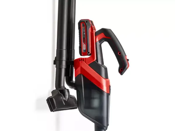 Akumulátorový ruční vysavač Einhell TE-HV 18/06 Li na nástěnném držáku s uloženým příslušenstvím.