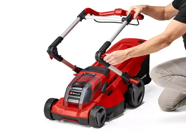 Az Einhell GE-CM 36/37 Li-Solo akkumulátoros fűnyíró összecsukható tolókarját éppen összecsukják.